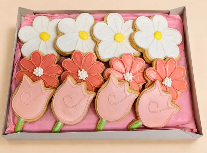 Boxed daisies, coral flowers, and tulips