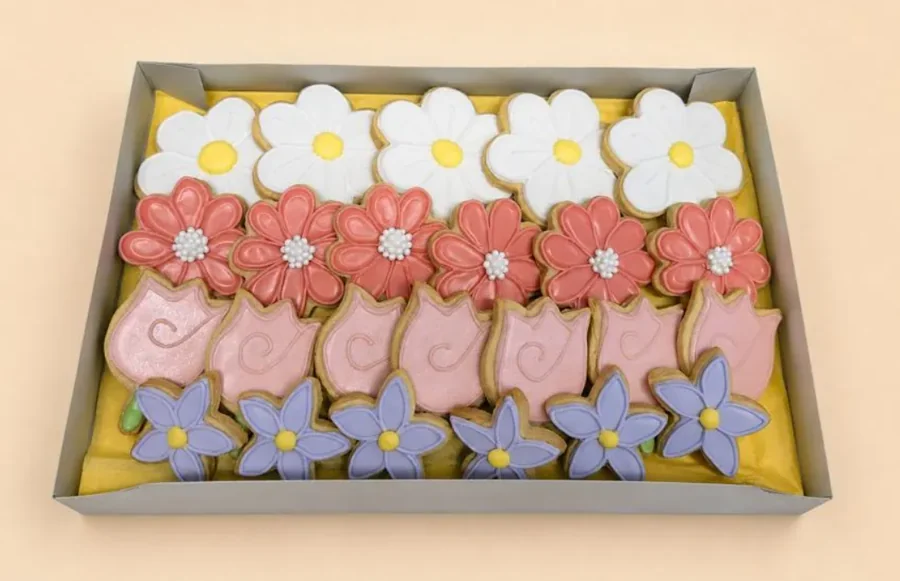 Boxed white daisies, coral flowers, pink tulips and purple flowers