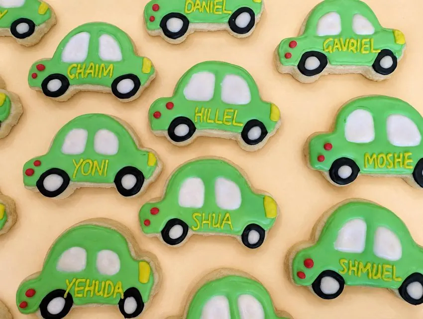 Green car cookies personalized with boys' names, close up