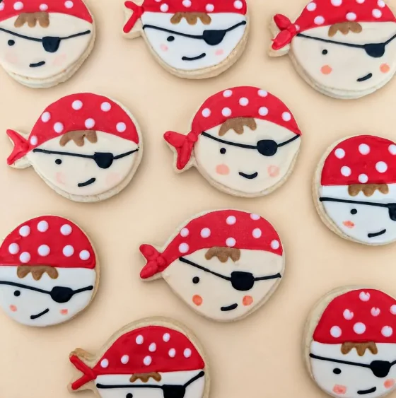 Pirate face cookies with red bandanas and eye patches